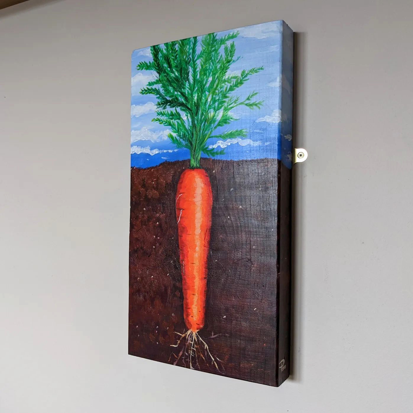 Painting of a carrot growing in the earth